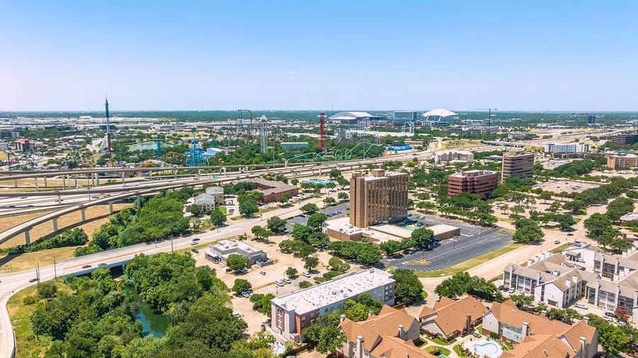 Arlington's Entertainment District from the air, with AT&T Stadium and Globe Life Field on the horizon