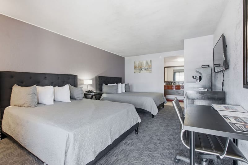 Standard Two Queen Beds Room with two queen beds and wall-mounted TV