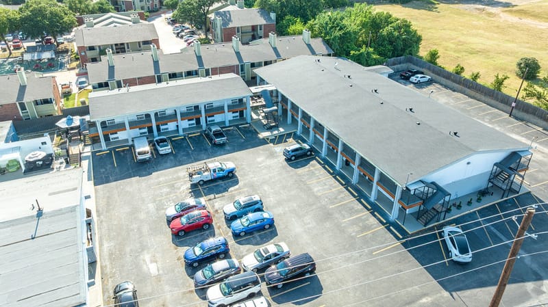 Aerial view of hotel guest buildings and on-site parking