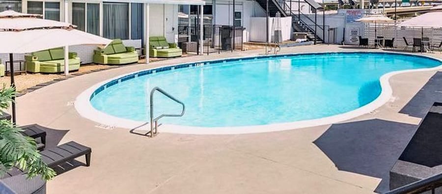 The seasonal outdoor pool at R Nite Star, with sun loungers and umbrellas around the water